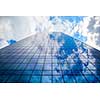 modern office building with glass front and sky reflection