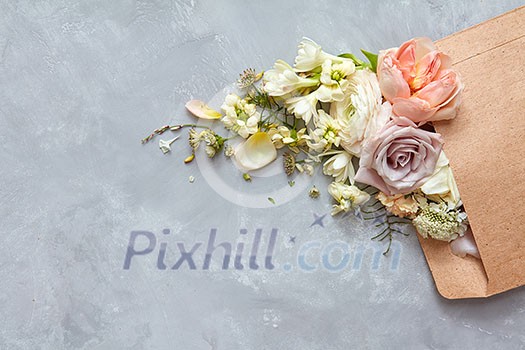 envelope with flowers on the stone gray background. flat lay