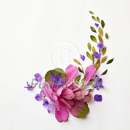 beautiful corner frame of delicate flowers on a light background with space for text, flat lay