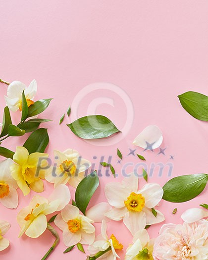 Wedding, Valentine's Day, Women's Day. Top view of white flowers with green leaves covering pink background. Blank copy space for noting emotions, ideas. Wedding, Valentine's Day, Women's Day. Top view of white flowers with green leaves covering pink background. Blank copy space for noting emotions, ideas.