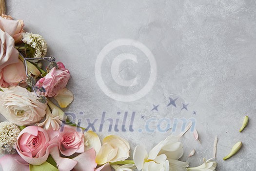 Frame of flowers decorating grey background. Top view of composition of white, pink roses designing grey background. B