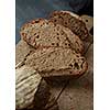 Sliced rye bread on cutting board closeup. The cut rye bread on wooden board brown. Healthy food. Proper nutrition. Bakery.