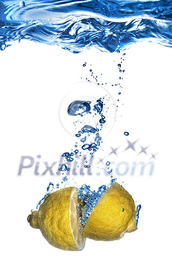 Fresh lemon dropped into water with bubbles isolated on white