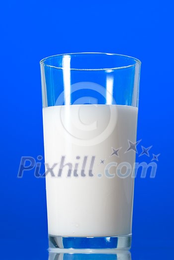 Milk in glass isolated on blue Milk in glass isolated on blue