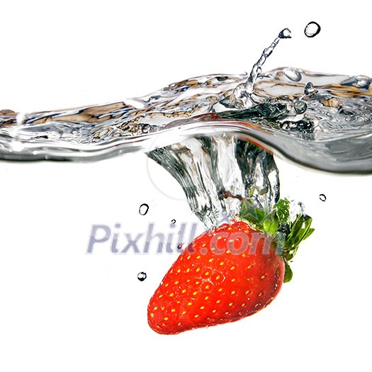 Fresh strawberry dropped into water with splash isolated on white