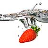 Fresh strawberry dropped into water with splash isolated on white