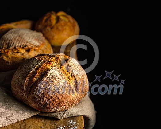 Fresh homemade bread on dark table. Rustic style. Fresh homemade bread on dark table. Rustic style.