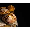 Fresh homemade bread on dark table. Rustic style. 