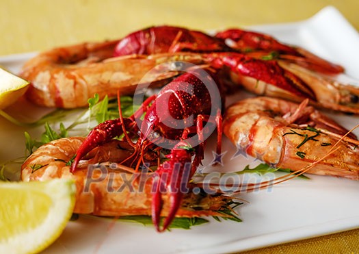 Cooked crawfish and shrimp on a plate with lemon.