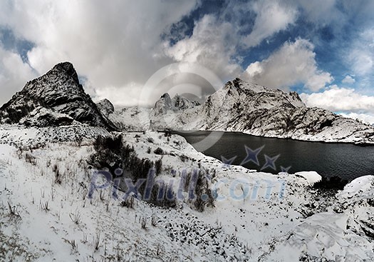 Panoramic view of the winter mountain landscape with a lake. Classical panorama of the Lofoten islands. Panoramic view of the winter mountain landscape with a lake. Classical panorama of the Lofoten islands.