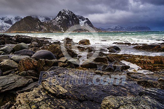 Rocky seashore. Magnificent winter mountain landscape on the sea. Lofoten Islands, Norway