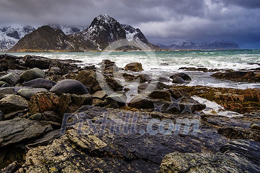 Rocky seashore. Magnificent winter mountain landscape on the sea. Lofoten Islands, Norway Rocky seashore. Magnificent winter mountain landscape on the sea. Lofoten Islands, Norway