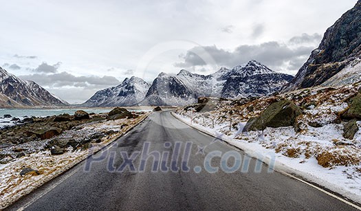 Empty asphalt road in the mountains in the Lofoten Islands, Norway. Empty asphalt road in the mountains in the Lofoten Islands, Norway.