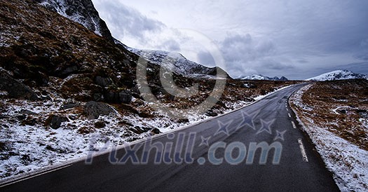 Empty asphalt road in the mountains in the Lofoten Islands, Norway. Empty asphalt road in the mountains in the Lofoten Islands, Norway.