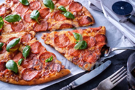 Homemade Pepperoni Pizza over black background. Homemade Pepperoni Pizza over black background.