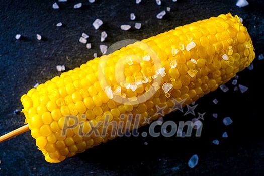 Boiled fresh corn with salt on the table Boiled fresh corn with salt on the table