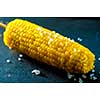 Boiled fresh corn with salt on the table