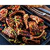 Roasted sliced barbecue pork ribs, seasoned with a spicy basting sauce and served with vegetables