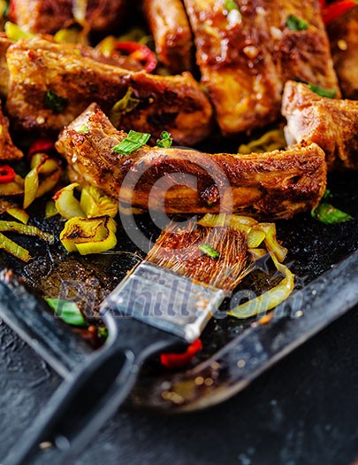 Roasted sliced barbecue pork ribs, seasoned with a spicy basting sauce and served with vegetables Roasted sliced barbecue pork ribs, seasoned with a spicy basting sauce and served with vegetables