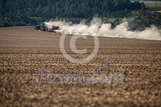Tractor plowing a dry farm field