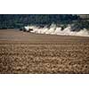 Tractor plowing a dry farm field