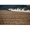 Tractor plowing a dry farm field