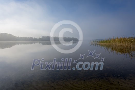 Foggy lake scenery in september Foggy lake scenery in september