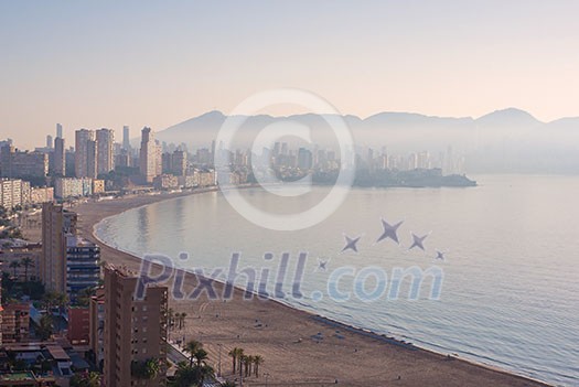 Aerial View from mountain of the city of Benidorm, Spain taken in the early morning when the city is covered with fog Aerial View from mountain of the city of Benidorm, Spain taken in the early morning when the city is covered with fog