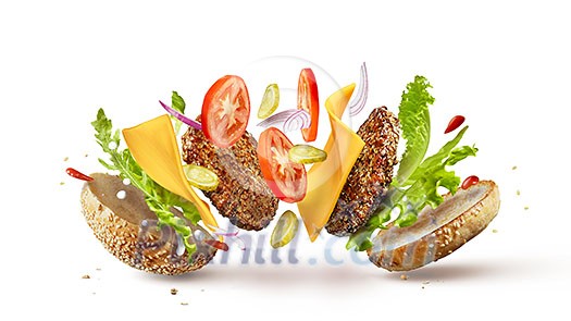 Burger preparation ingredients falling into place isolated on white Burger preparation ingredients falling into place isolated on white