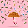 Umbrella made of waffle and Christmas candy on a pink background.