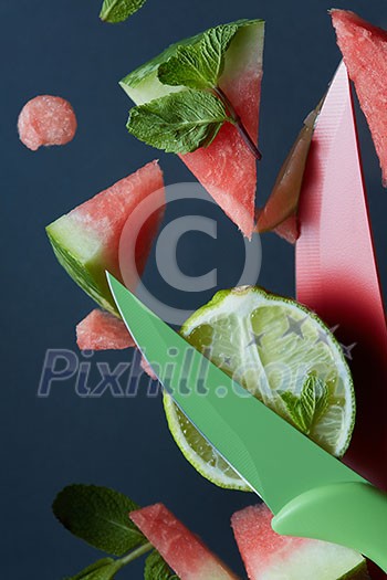 watermelon and lime slices with knife on a plate watermelon and lime slices with knife on a plate