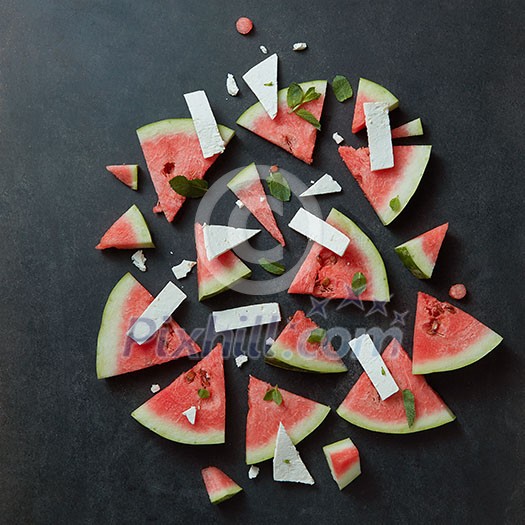 watermelon slices with cottage cheese on a black concrete background , top view