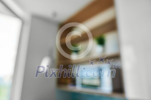 Natural lens bokeh.Blurred view of kitchen interior with shelves, vases and microwave near the window Natural lens bokeh.Blurred view of kitchen interior with shelves, vases and microwave near the window