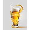 A cold glass of beer and a splash around it isolated on a gray background