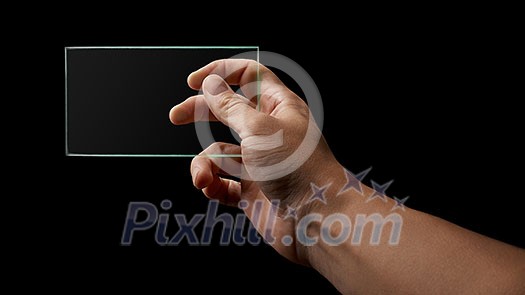 human hand holds a transparent glass on a black background place for text