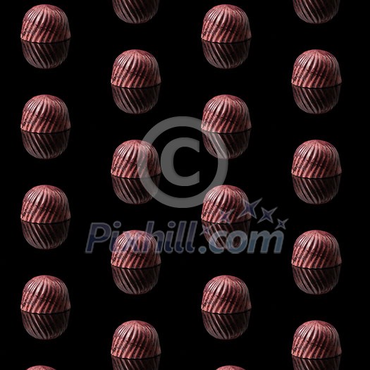 pattern, background of chocolate sweets. tasty candy on a black texture. pattern, background of chocolate sweets. tasty candy on a black texture.