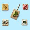 different sandwiches with different ingredients. one sandwich on a wooden kitchen board on a blue background flat lay