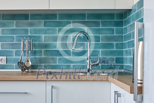 Kitchen Modern white furniture on the wall background with blue tiles