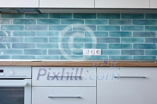 Equipped kitchen with kitchen appliances in a modern style in white and blue tones Equipped kitchen with kitchen appliances in a modern style in white and blue tones