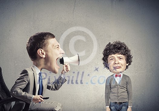 Funny young man with big head screaming emotionally in megaphone Funny young man with big head screaming emotionally in megaphone