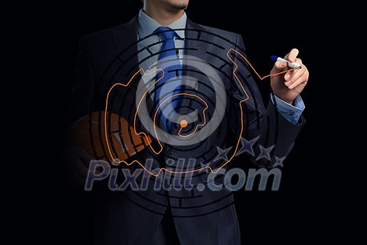 Close up of businessman drawing way out of labyrinth