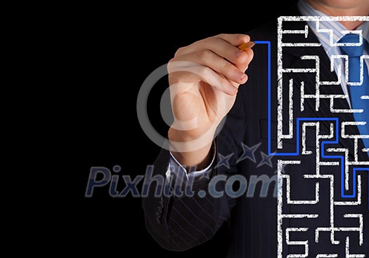 Close up of businessman drawing way out of labyrinth