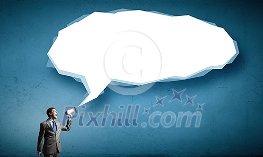 Young businessman in suit screaming emotionally into megaphone Young businessman in suit screaming emotionally into megaphone