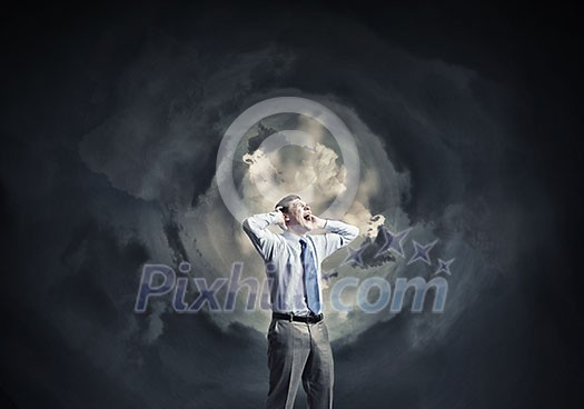 Frustrated businessman screaming emotionally with hands on head Frustrated businessman screaming emotionally with hands on head