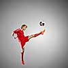 Soccer player kicking ball isolated over white background