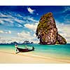 Thailand tropical vacation concept background - Vintage retro effect filtered hipster style image of long tail boat on tropical beach with limestone rock, Krabi, Thailand