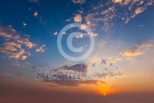 Evening sunset sky with sun and dramatic clouds Evening sunset sky with sun and dramatic clouds