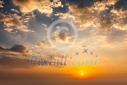 Evening sunset sky with sun and dramatic clouds Evening sunset sky with sun and dramatic clouds