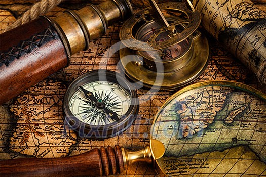 Travel geography navigation concept background - old vintage retro compass, sundial, magnifying glass and spyglass on ancient world map