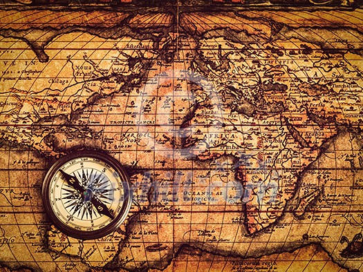 Travel geography navigation concept background - vintage retro effect filtered hipster style image of old vintage retro compass on ancient world map Travel geography navigation concept background - vintage retro effect filtered hipster style image of old vintage retro compass on ancient world map